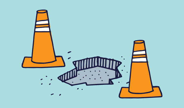 illustration of traffic cones near a pothole