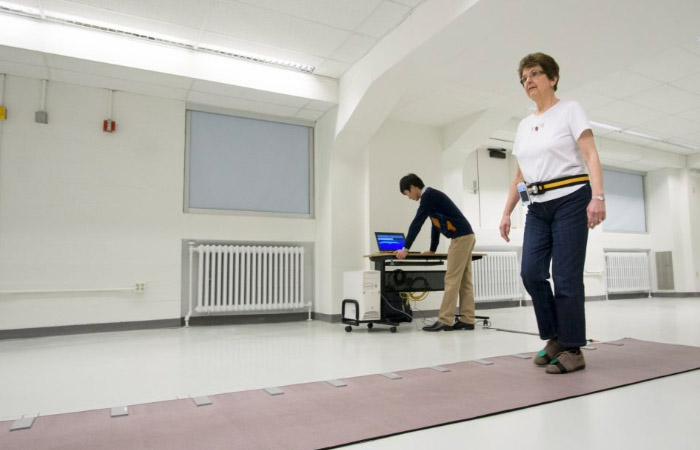 an elderly woman performs a walking test