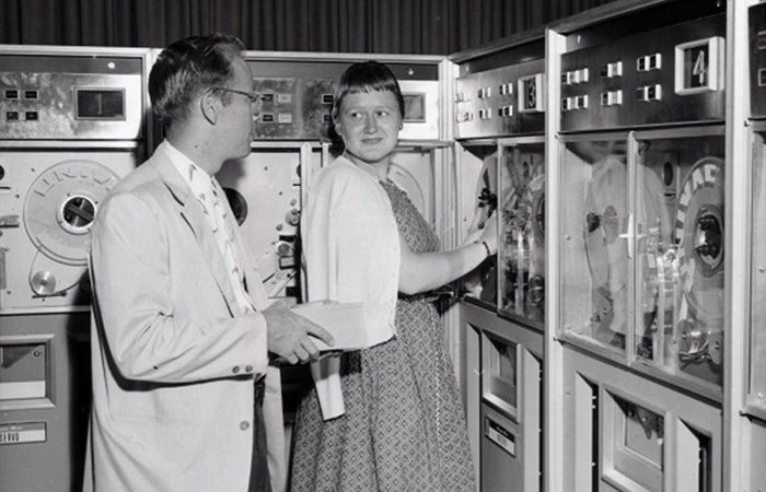 archive photo of a man and woman using a huge computer