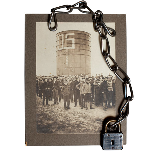 padlock laying on a picture of people and a water tank