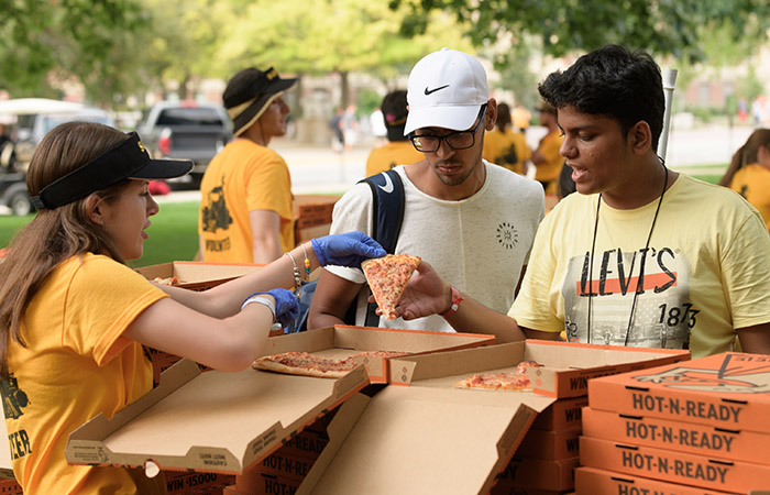 students enjoying free pizza at a club callout