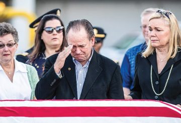 a crying man salutes lieutenant Bardachs casket