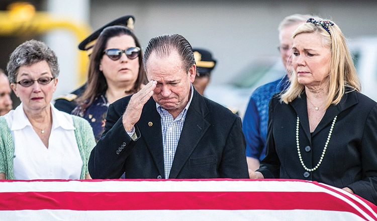 a crying man salutes lieutenant Bardachs casket