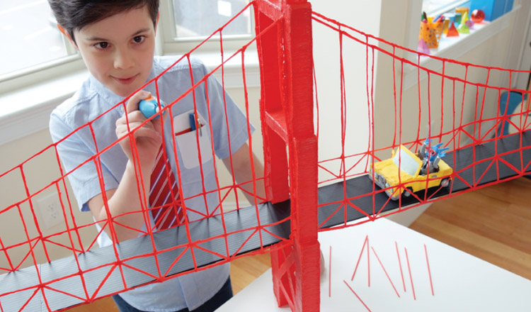 A boyu uses a 3d pen to sculpt a bridge