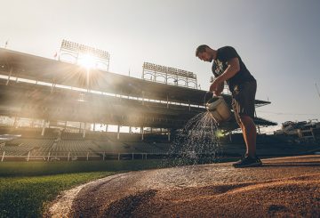 Dan Kiermaier waters the pitcher’s mound at Wrigley Field in Chicago.