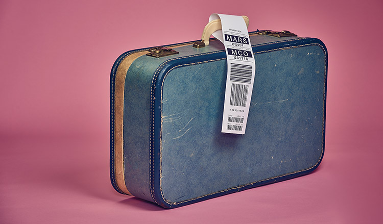 a suitcase with an airline tag that indicates the luggage should be sent to mars