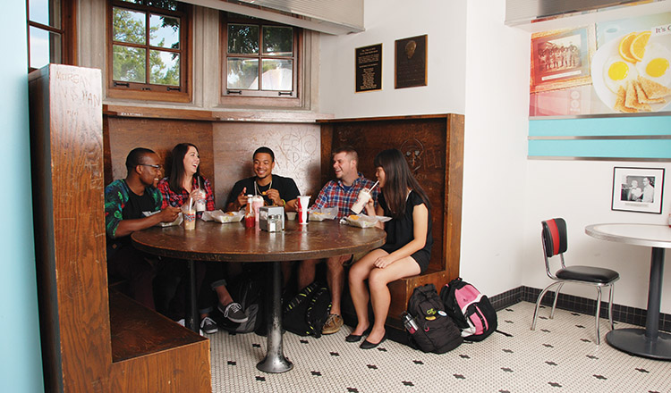 a group of students sitting in the corner booth at Pappy's