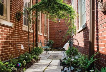 Limestone pavers lead to a burbling fountain in the hidden courtyard at Duncan Hall.