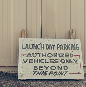 Sign that says launch day parking. authorized vehicles only beyond this point