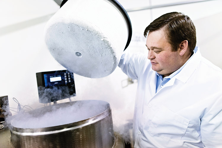 a scientist inspects a cryogenic tank