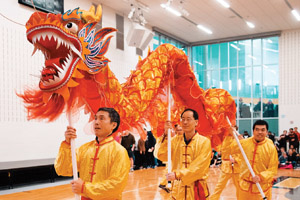 asian men carrying a chinese dragon