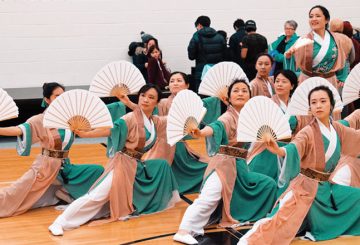 asian women performing a traditional dance with fans